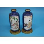 A pair of Kangxi period vases, the powder blue ground decorated with famille verte panels on