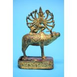 A gilt bronze Indian multi-armed deity surmounted on an Oxen. 13 cm high by 9 cm wide