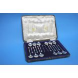 A cased set of twelve silver teaspoons and a pair of sugar tongs, with trefoil ends, Sheffield 1912,