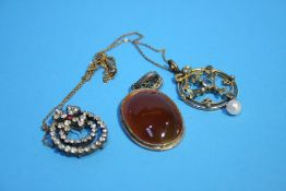 An Edwardian circular pendant and chain, an agate pendant etc.