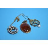 An Edwardian circular pendant and chain, an agate pendant etc.