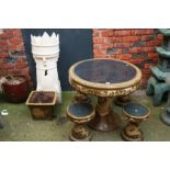 An Oriental style garden table with four matching stools and a plant pot