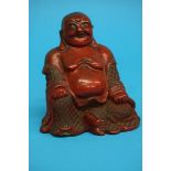 An 18th/19th Century Cinnabar lacquer figure of Budai. 15 cm high