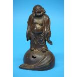 A 19th Century Yixing model of a Buddha, with seal mark to base. 24 cm high