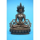 A bronze figure of a Buddha inlaid with coral and turquoise. 16 cm high by 12 cm wide