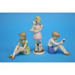 A Goebel figure of a girl holding a dog, GF 83 and two figures of a boy and girl seated