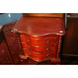 A serpentine fronted chest of three drawers