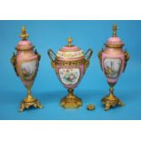 A Continental porcelain three piece garniture, each vase decorated on a pink Sevres style ground