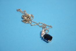 An 18ct white gold sapphire and diamond pendant
