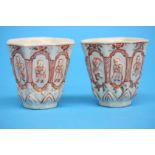 A pair of 18th Century blanc de chine octagonal wine cups decorated with panels of children at play.