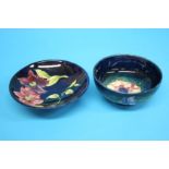 A Moorcroft circular bowl on a blue ground, decorated with 'Pansies' and another shallow bowl