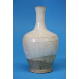A Song dynasty Cizhou bottle vase in cream glaze, the glaze fallen short to reveal a buff body. 20