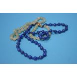 A string of lapis lazuli beads with gold clasp and a set of hardstone beads