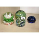 Four paperweights including two Mdina