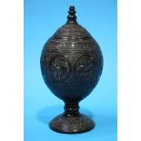 A carved coconut shell, decorated with fish, turtles etc.