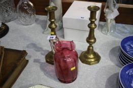 Pair of candlesticks and a cranberry jug