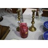 Pair of candlesticks and a cranberry jug