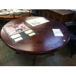 A circular mahogany dining table