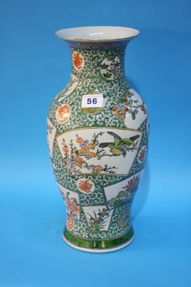 An Oriental vase with panels, decorated with birds