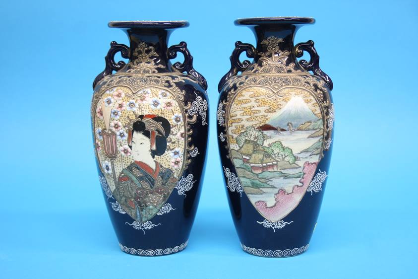 A pair of 1920/1930's Satsuma vases decorated with panels of landscapes etc. 25cm height