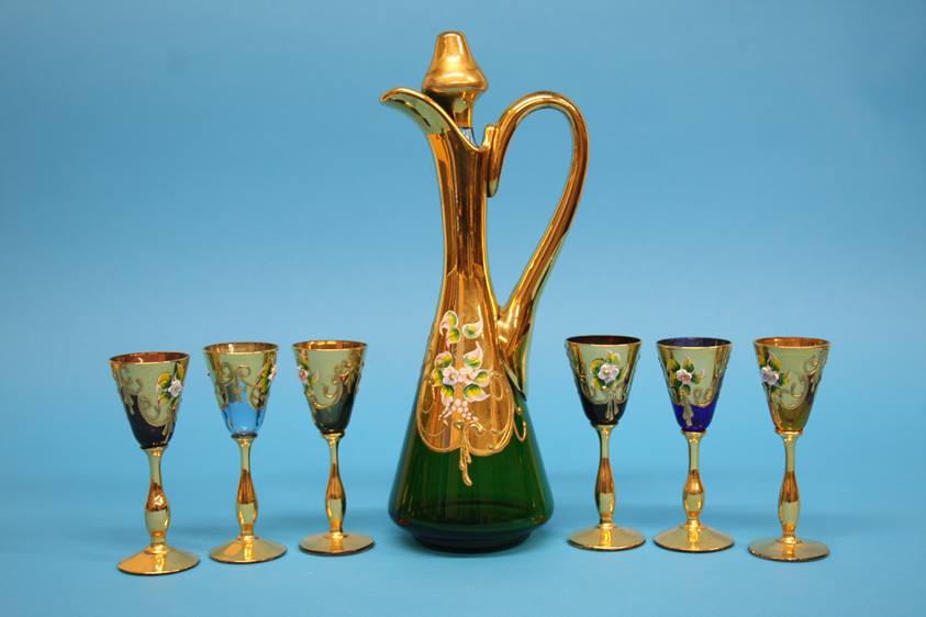 A Continental coloured glass liqueurs set comprising gilt and enamelled decanter and six small