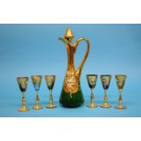 A Continental coloured glass liqueurs set comprising gilt and enamelled decanter and six small