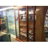 A modern mahogany breakfront display cabinet