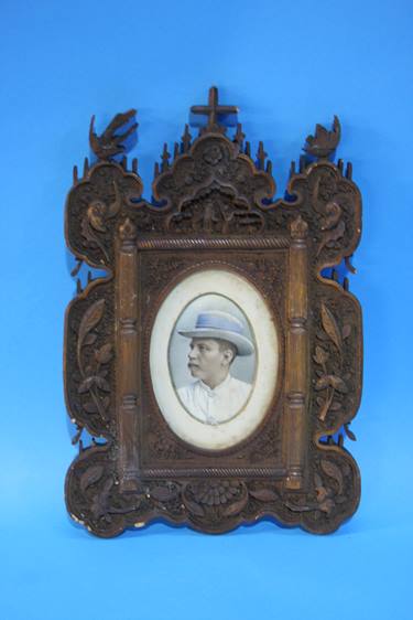 Pair of heavily carved frames containing two overpainted portraits of a Lady and a Gentleman