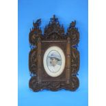 Pair of heavily carved frames containing two overpainted portraits of a Lady and a Gentleman