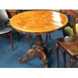 A heavily carved Continental inlaid tripod table