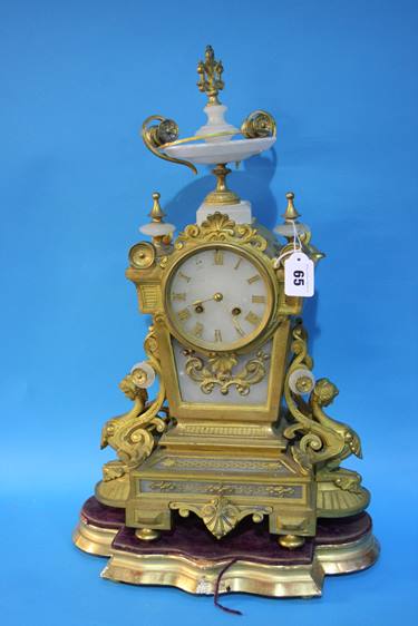 A gilt metal and marble mantle clock