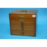 A 19th Century mahogany travelling Dentist's cabinet with rising top, opening to reveal a filled