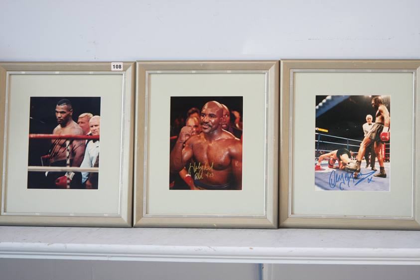Three framed photographs of boxing legends each signed, Mike Tyson, Evander Holyfield and Nigel