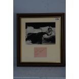 Gloria Swanson (1899 - 1983), signed page, mounted with black and white photograph of Swanson posing