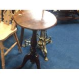 An Edwardian mahogany tripod wine table