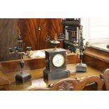 A slate mantle clock and garniture