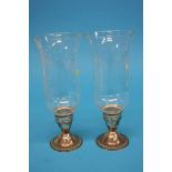 A pair of sterling silver hurricane lamps (weighte