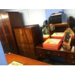 A mahogany triple door wardrobe, matching tall boy and dressing table