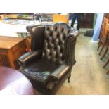 A good pair of Chesterfield wing back armchairs, with button backs, supported on cabriole legs