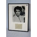 Elizabeth Taylor (1932 - 2011) signed album page together with a black and white photograph, framed