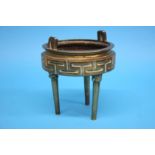 A bronze tripod censer with lion mask terminals and geometric design. 17 cm diameter by 20 cm high