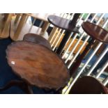 A walnut occasional table and a mahogany plant stand