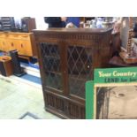 An oak leaded glass bookcase