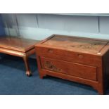 A carved Oriental camphor wood lined trunk and matching coffee table