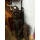 2 carved figures and a walking stick