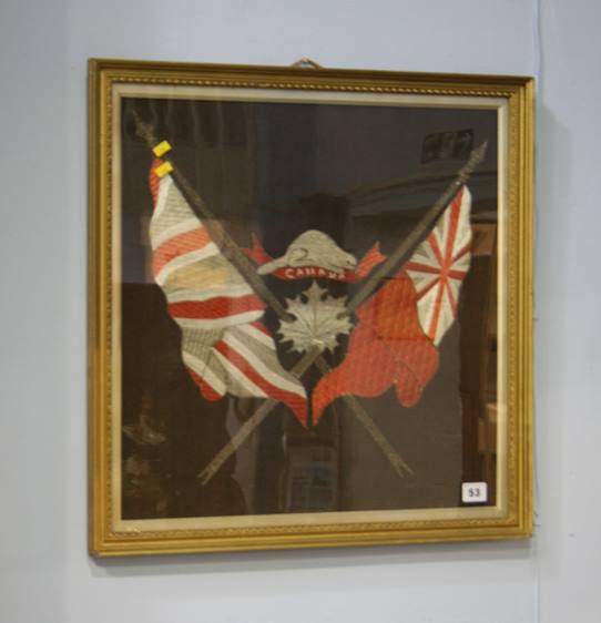 A framed embroidery of the Canadian and British flags