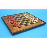 A stained bone chess set and chess board