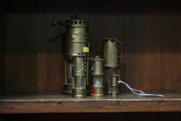 Group of five miniature Miners lamps