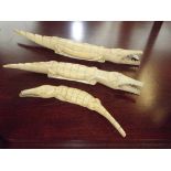 Three walrus tusk crocodiles