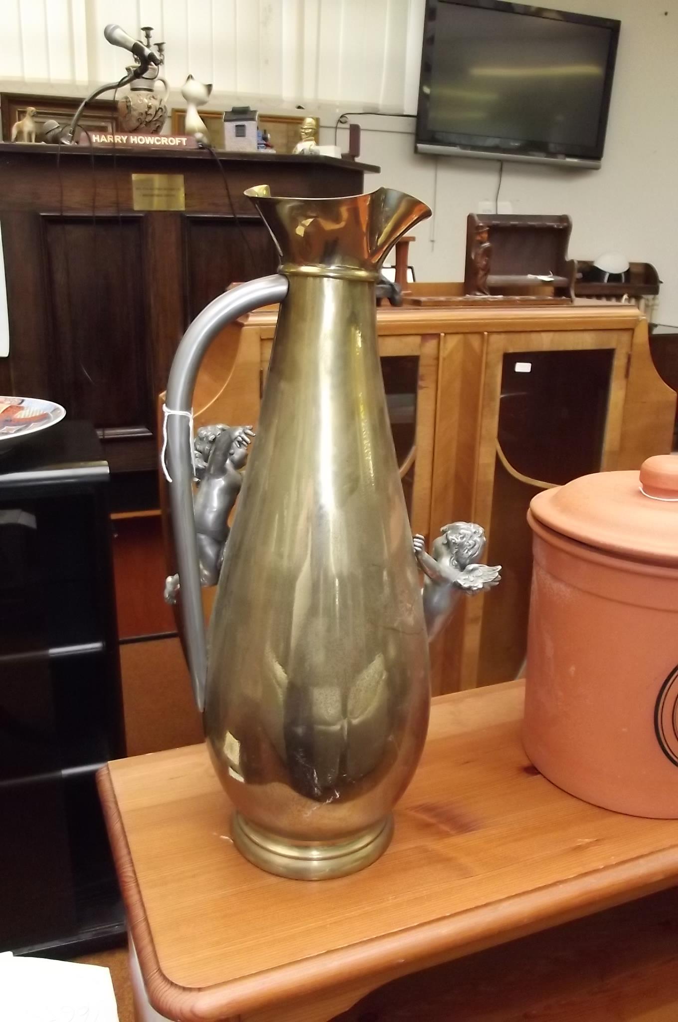 Large brass jug with applied plated cherubs